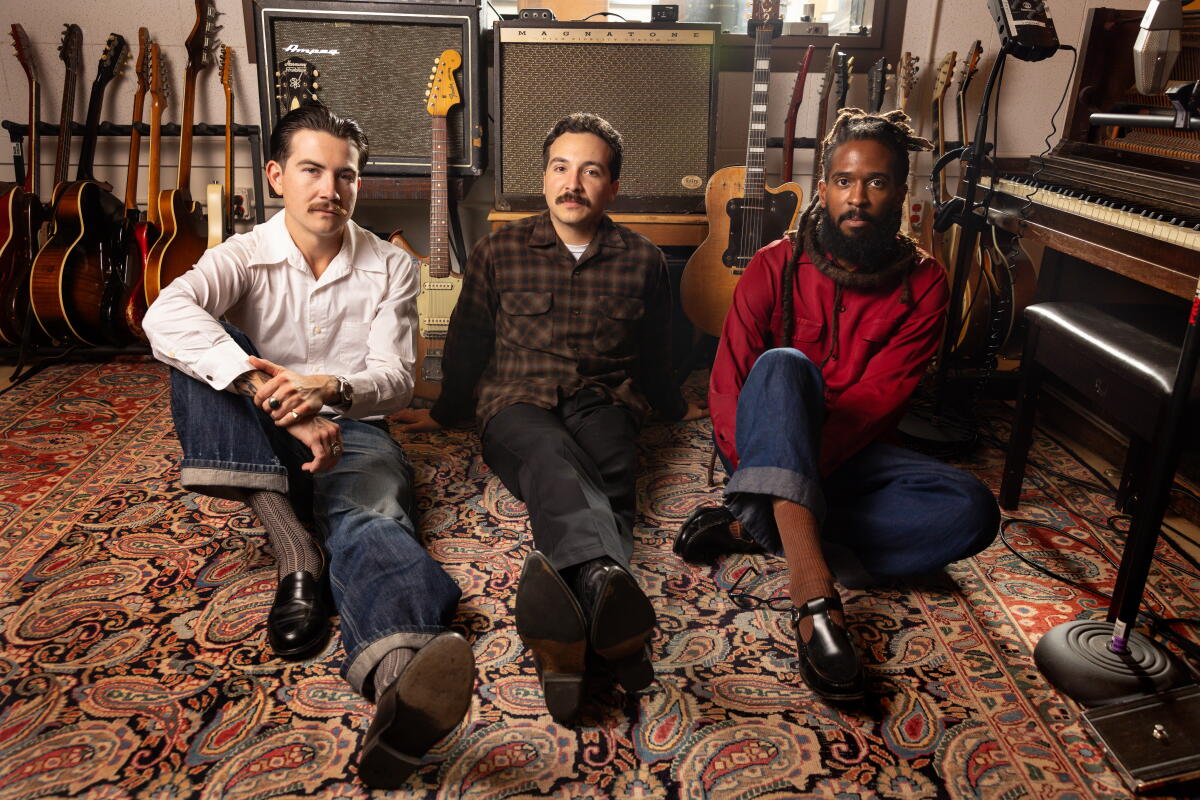Thee Sacred Souls seated in a music studio